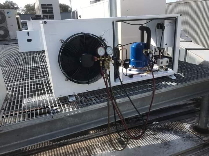 Air conditioning expert servicing a residential AC unit in Durban