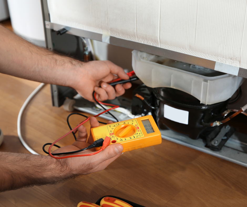 Male technician in CoolTech uniform holding electrical testing equipment during appliance inspection